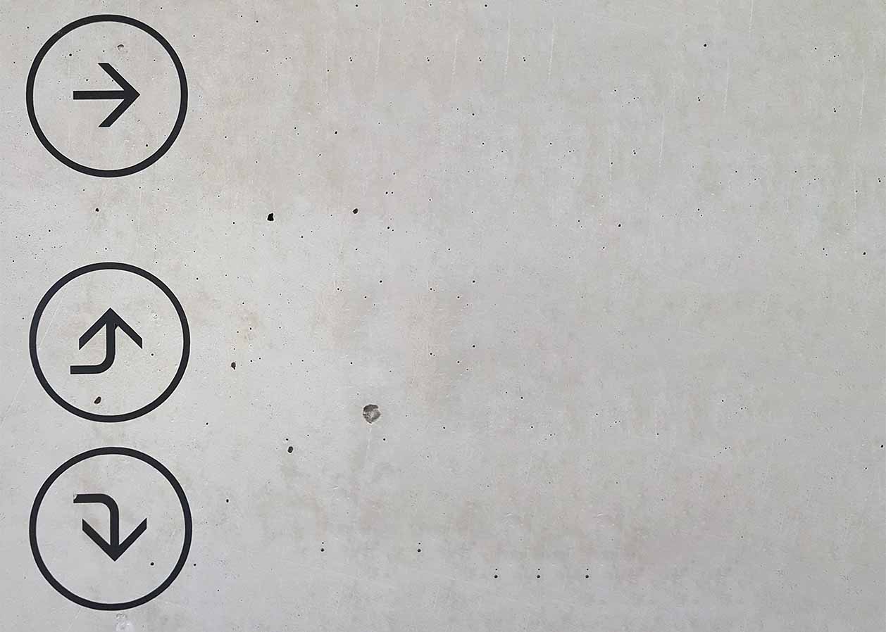 Photo of arrows on a wall pointing in different directions